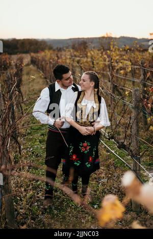 A close-up shot of a young Serbian couple in traditional costume in the field Stock Photo