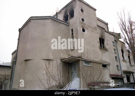 Bukarest, Rumänien, Januar 1990. Das Gebäude in der Pangratti-Straße, in der Nähe des Hauptquartiers des öffentlichen rumänischen Fernsehsenders, wurde durch die Schüsse während der antikommunistischen Revolution im Dezember 1989 beschädigt. Stockfoto