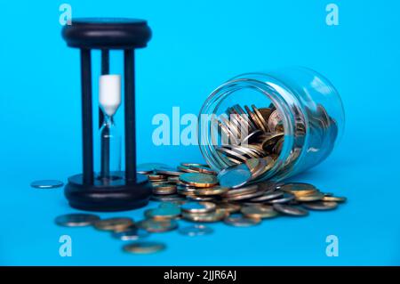 Verstreute Goldmünzen und Minuten Glas mit Platz anpassbar für Text oder Ideen . Platz und Geschäftskonzept kopieren Stockfoto