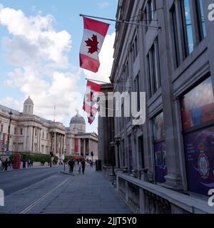 London, Greater London, England, Juni 30 2022: Kanadische Flaggen vor der kanadischen Botschaft mit der Nationalgalerie im Hintergrund. Stockfoto