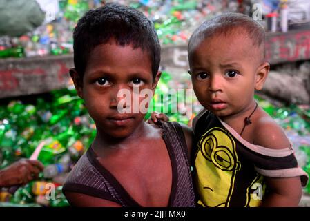 Kinderarbeiter sortieren am 27. Juli 2022 in einer Recyclingfabrik in Dhaka, Bangladesch, Polyethylenterephthalat (PET)-Flaschen. Recycling von Kunststoff Stockfoto