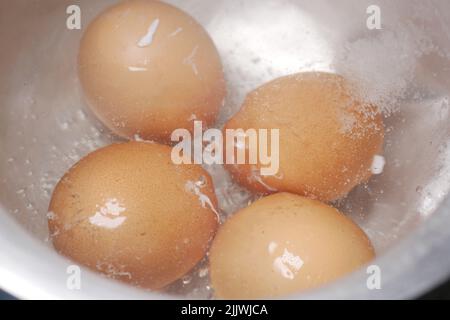 Nahaufnahme kochender Eier in einer Schüssel. Stockfoto