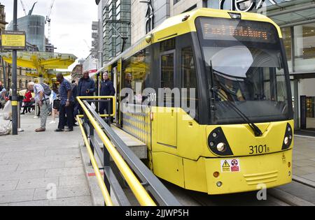 Eine Straßenbahn von Manchester Metrolink im Stadtzentrum von Manchester, Greater Manchester, England, Großbritannien, Britische Inseln. Die Straßenbahnen von Manchester Metrolink sollen ab dem 1. August 2022 Heimhunde in den Straßenbahnen von Greater Manchester für ein dreimonatiges Pilotprojekt zulassen. Derzeit sind nur Assistenzhunde mit Behinderungen in den Straßenbahnen erlaubt. Stockfoto