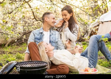 Glückliche Familie mit Grill mit modernen Grill im Freien Stockfoto