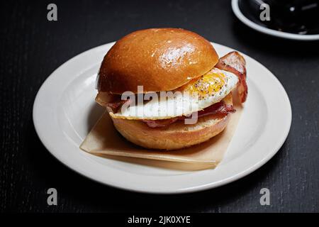 Brioche-Frühstück mit Eiern und Speck, bap Stockfoto