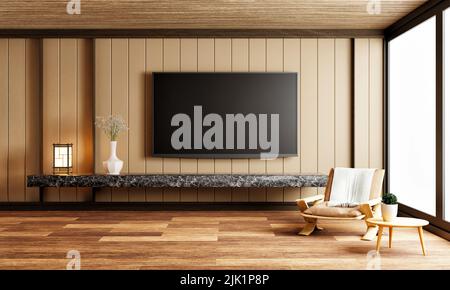 Fernseher über der Arbeitsplatte aus schwarzem Marmor in einem modernen, leeren Zimmer mit Teppich aus Stuhlpflanzen auf Holzhintergrund. Japanisches Onsen- und Spa-Stil. Architektur Stockfoto