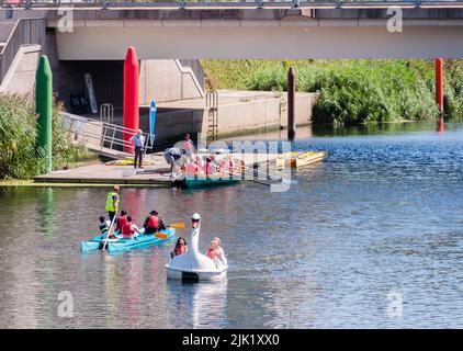 Die Menschen genießen das heiße Wetter von Schwimmern auf dem Fluss Waterworks, der durch den Olympiapark fließt Stockfoto