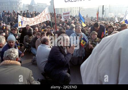 Bukarest, Rumänien, 28. Januar 1990. Einen Monat nach der antikommunistischen Revolution marschieren Anhänger der historischen (rechten) Parteien gegen das neue politische System, das sich hauptsächlich aus ehemaligen kommunistischen Funktionären zusammensetzt. Die Teilnehmer hielten für einen Moment des Gebets an. Stockfoto