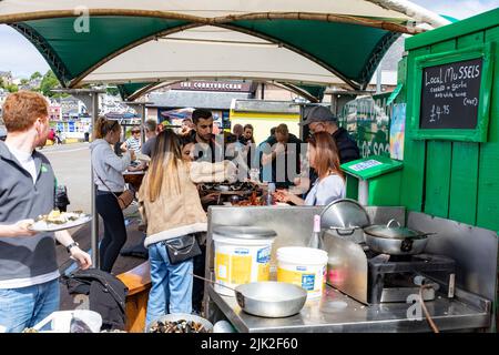 Oban Scotland, Menschen essen frische Meeresfrüchte Schalentiere aus dem Green Shack auf Oban Pier, Argyll, Schottland, UK Sommer 2022 Stockfoto