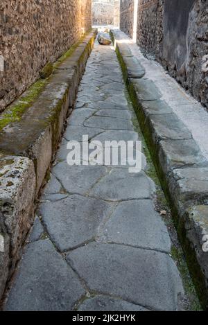 Eine schöne, typische gepflasterte Straße in der antiken Stadt Pompeji, Süditalien Stockfoto