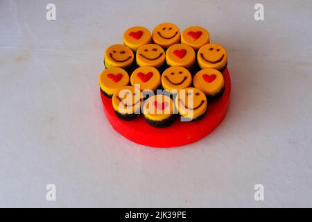 Kleine gelbe Kuchen mit Herdform und Smiley Stockfoto