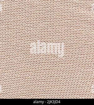 Gestrickte, cremefarbene, klare Winterstruktur. Wolle cremefarbene Pullover Textur Nahaufnahme. Stockfoto