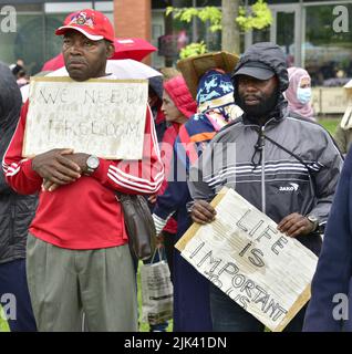 Ein Protestler bei einem von RAPAR organisierten Protest, der im Rahmen seiner Kampagne gegen SERCO, die Flüchtlinge und Asylsuchende in Piccadilly Gardens, im Zentrum von Manchester, England, Vereinigtes Königreich, unterbringt, Britische Inseln. RAPAR sagt, dass es „darauf abzielt, die Fehler von SERCO bei der Bereitstellung angemessener Unterkünfte und Unterkünfte hervorzuheben“. Stockfoto