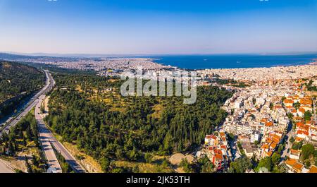 Drohnenansicht der Hafenstadt - Thessaloniki - zeigt übersäte weiße Häuser mit orangefarbenem Dach. Sonniges Wetter. Konzept der Sommerreise. Hochwertige Fotos Stockfoto