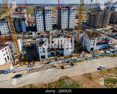 Auf großen Baustellen arbeiten Arbeiter aus der Luft, und viele Krane arbeiten Stockfoto
