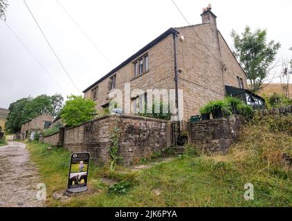 Edale, Derbyshire, Großbritannien, Juli 26 2022 Bauernhaus über den Zugang zu Kinder Scout mit einem Schild im Vordergrund, das für ein Fotogeschäft wirbt Stockfoto