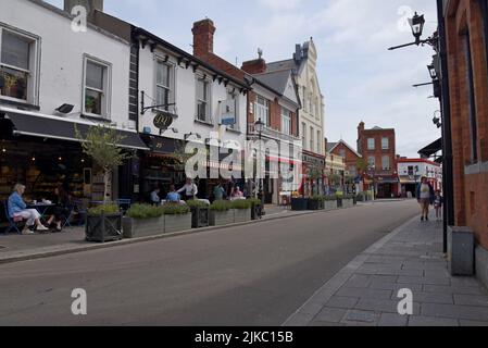 In der Castle Street, der Hauptstraße von Dalkey, Leinster, Irland, können Sie Menschen stöbern, einkaufen und essen. Juli 2022 Stockfoto