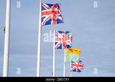 Besuchen Sie die Flaggen Southend und Union Jack, die bei starkem Wind auf der Western Esplanade, Southend on Sea, Essex, Großbritannien, fliegen. Tourismus für Küstenstadt, Stadt Stockfoto