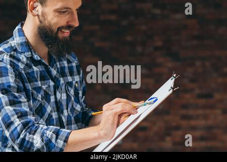 Kunst leidenschaftliche kreative junge Mann Malerei Stockfoto