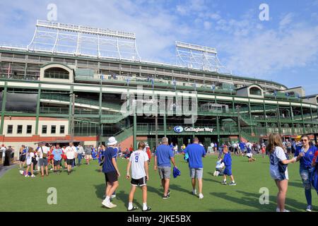 Chicago, Illinois, USA. Gallagher Way direkt vor dem legendären Wrigley Field ist ein Kunstrasen-Grünfläche für Inhaber von Spielkarten. Stockfoto