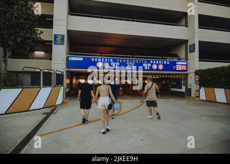 Italien. Venedig. 09.07.2022 Vor dem Hintergrund eines Sonnenuntergangs in Venedig Läuft Eine Gruppe von Menschen auf den Parkplatz zu. Reisen mit Freunden Touristen Stockfoto