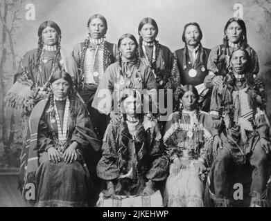 Historisches Schwarz-Weiß-Foto aus den späten 1890er Jahren einer Gruppe von Männern und Frauen aus der Südlichen Ute, die in traditionellen Regalien gekleidet waren. Colorado Stockfoto