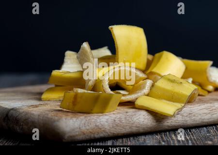 Die gelbe Schale, die nach den Bananen auf dem Brett zurückgelassen wurde, die leere Schale der Bananen, nachdem sie gereinigt wurden, das ist Müll Stockfoto