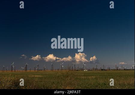 Windturbinen Windmühle Energy Farm auf grünem Feld und blauem Himmel Stockfoto