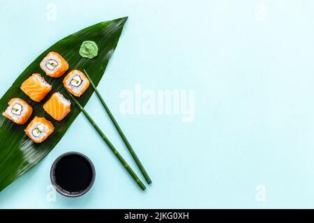 Sushi-Rollset Eco serviert auf grünem Bambusauslass, Draufsicht Stockfoto
