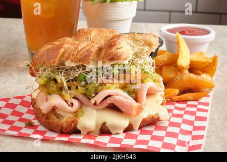 Ein frisches putencroissant mit Pommes Frites, Saft und Ketchup Stockfoto