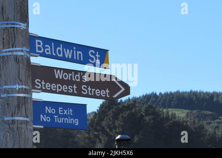 Nahaufnahme eines Postes mit Straßenschildern zur Baldwin Street, Neuseeland in Dunedin Stockfoto