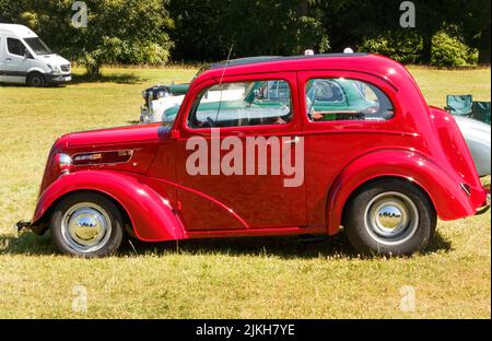 Seitenansicht des leuchtend roten 1940s Ford Anglia Stockfoto