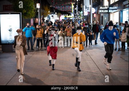 Eine Gruppe von vier Tänzern, die nachts auf der Straße choreografieren. Stockfoto