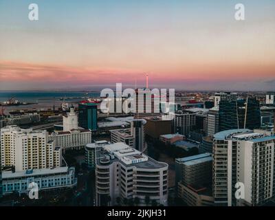 Ein leuchtender, pinkfarbener Sonnenuntergang über modernen Gebäuden in Kapstadt, Südafrika Stockfoto
