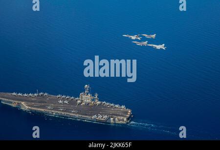 Mittelmeer, Italien. 29. Juli 2022. US Navy F/A-18E Super Hornet Kampfflugzeuge, die an Carrier Air Wing 1 und die belgische Luftwaffe F-16 Kampfflugzeuge angeschlossen sind, fliegen in Formation über den Nimitz-Klasse Flugzeugträger USS Harry S. Truman segelt in Formation während des Rim of the Pacific im Pazifischen Ozean, Juli 25, 2022 im Mittelmeer. Kredit: Navy Foto/Planetpix/Alamy Live Nachrichten Stockfoto