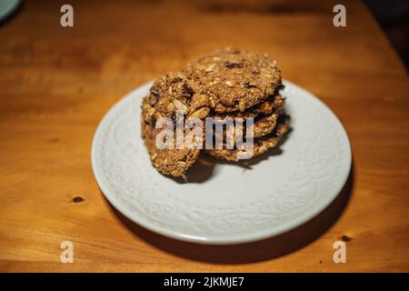 Eine Nahaufnahme von Keksen mit Schokolade und Nüssen auf einem weißen Teller Stockfoto
