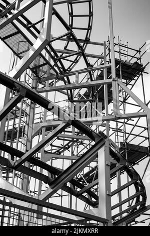 Eine Graustufenaufnahme der Achterbahnschienen am Brighton Pier. Vereinigtes Königreich. Stockfoto