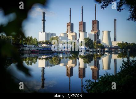 Berlin, Deutschland. 03. August 2022. Das Erdgas-basierte Blockheizkraftwerk Lichterfelde spiegelt sich am frühen Morgen im Teltow-Kanal wider. Das Kraftwerk versorgt rund 100.000 Haushalte mit Strom und Fernwärme. Das Kraftwerk wird vom Energieunternehmen Vattenfall betrieben. Das Kraftwerk wird mit Erdgas betrieben. Quelle: Kay Nietfeld/dpa/Alamy Live News Stockfoto