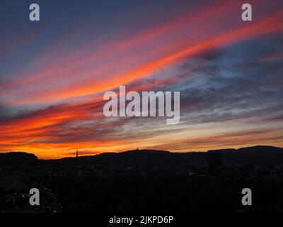 Panoramablick auf die Silhouette der Stadt Linz bei Sonnenuntergang mit schönen kleinen Wolken, Skyline der Stadt bei Sonnenuntergang Stockfoto