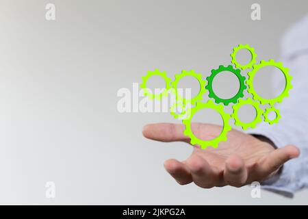 Ein 3D Design von Mechanismus grünen Zahnräder und Zahnräder bei der Arbeit auf schwarzem Hintergrund. Stockfoto