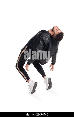 Foto in voller Länge von einem lustigen Kerl tanzen im Studio isoliert auf weißem Hintergrund. Stockfoto