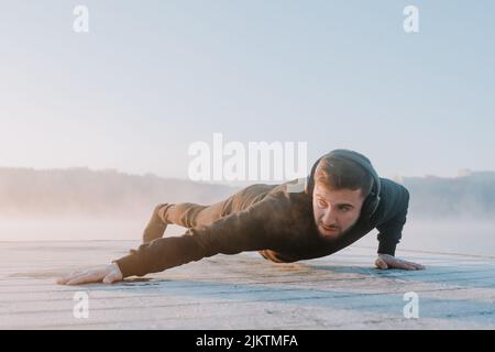Mann hört Musik und macht Morgensport. Stockfoto