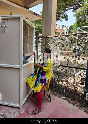 Bangalore, Karnataka, Indien-11. April 2022: Nahaufnahme des Covid- oder Corona-Tests mit dem indischen Mädchen vom Stand des Krankenhauses draußen. Stockfoto