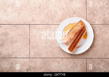 Rosh Hashanah. Süße Waben mit Honig, Apfel und Granatapfel auf hellbeigem, rustikalem Beton-Hintergrundtisch. Jüdische Neujahrsfeiertage begrüßen Stockfoto