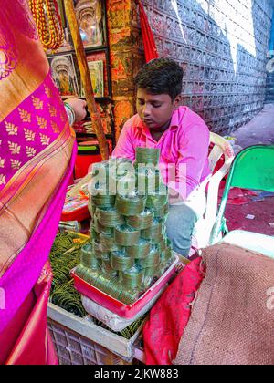 Tuljapur, Indien- Dezember 19. 2019; Stock Foto von 13 bis 15 gealterten indischen Jungen in rosa Hemd und grauer Hose, Verkauf von grünen Farbe g Stockfoto