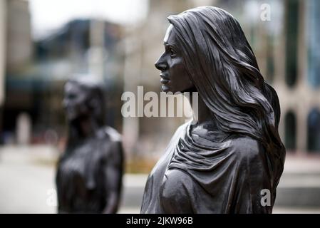 Eine Statue der 'Real Birmingham Family' vor der Bibliothek von Birmingham auf dem Centenary Square Stockfoto