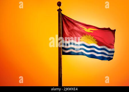 Die Nationalflagge von Kiribati auf einem Fahnenmast isoliert auf einem orangen Hintergrund Stockfoto