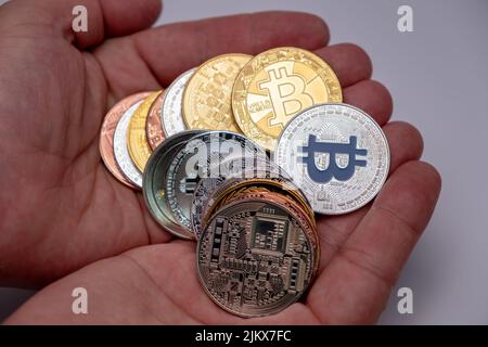 Viele Bitcoins-Münzen auf Handinnenhand. Kryptowährungskonzept, Bitcoin BTC auf Handinnenhand stehend. Kryptowährung liegt auf Mann zwei Hände Close-Up. Stockfoto