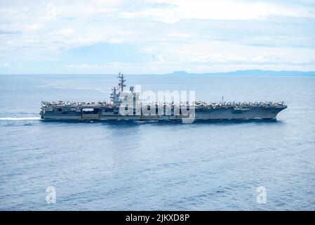 Straße Von San Bernardino. 1. August 2022. Der einzige vorwärts eingesetzte Flugzeugträger der US-Marine USS Ronald Reagan (CVN 76) führt eine Inselgruppe durch die Straße von San Bernardino. Ronald Reagan, das Flaggschiff der Carrier Strike Group 5, stellt eine kampfbereite Kraft zur Verfügung, die die Vereinigten Staaten schützt und verteidigt und Allianzen, Partnerschaften und kollektive maritime Interessen in der Indo-Pazifik-Region unterstützt. (USA Navy Foto von Mass Communication Specialist 3. Klasse Oswald Felix) Quelle: U.S. Navy/ZUMA Press Wire Service/ZUMAPRESS.com/Alamy Live News Stockfoto