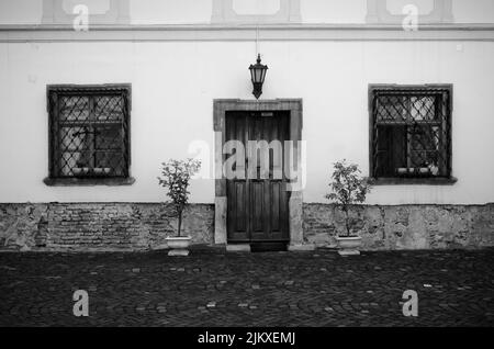 Eine Graustufenaufnahme einer alten Hausfassade in Sibiu, Siebenbürgen, Rumänien Stockfoto